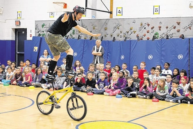 Chris Poulos shows off his balancing skills during an assembly at Circleville Elementary School.