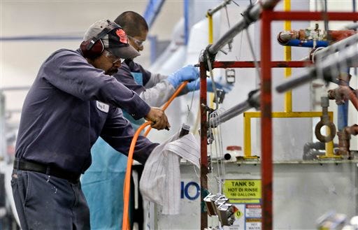 In this Thursday, Oct. 10, 2013, file photo, employees at Sheffield Platers Inc. work on the factory floor in San Diego. The Commerce Department releases fourth-quarter gross domestic product on Thursday, Jan. 30, 2014 (AP Photo/Lenny Ignelzi, File)