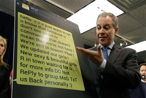 New York Attorney General Eric Schneiderman shows an enlarged text message as he addresses a news conference, in New York, Thursday, Jan. 30, 2014. Police were rounding up 18 people in New York City on Thursday on allegations they sold "party packs" of cocaine and sex to high-end clients and texted their customers to advertise ahead of this week's Super Bowl festivities. (AP Photo)
