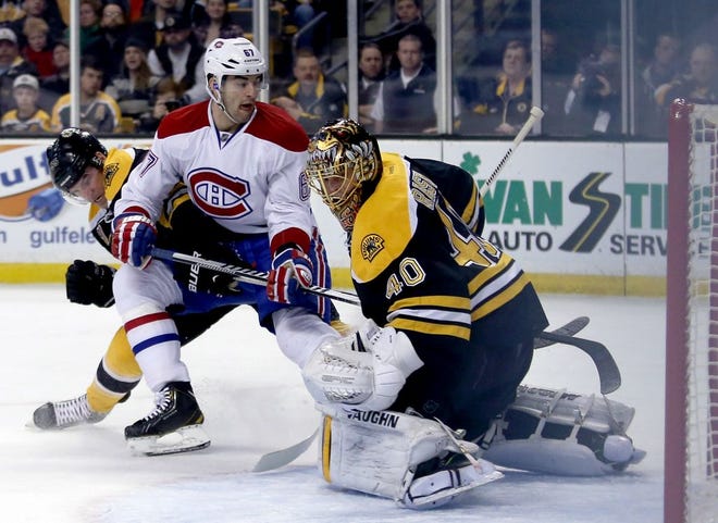 Montreal Canadiens left wing Max Pacioretty (67) puts the puck into the net past Boston Bruins goalie Tuukka Rask during the first period of an NHL hockey game on Thursday, Jan. 30, 2014, in Boston.