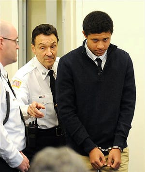In this Dec. 4, 2013 file photo, Phillip Chism, 14, from Danvers, Mass., is lead into the courtroom at his arraignment in Salem Superior Court in Salem, Mass.