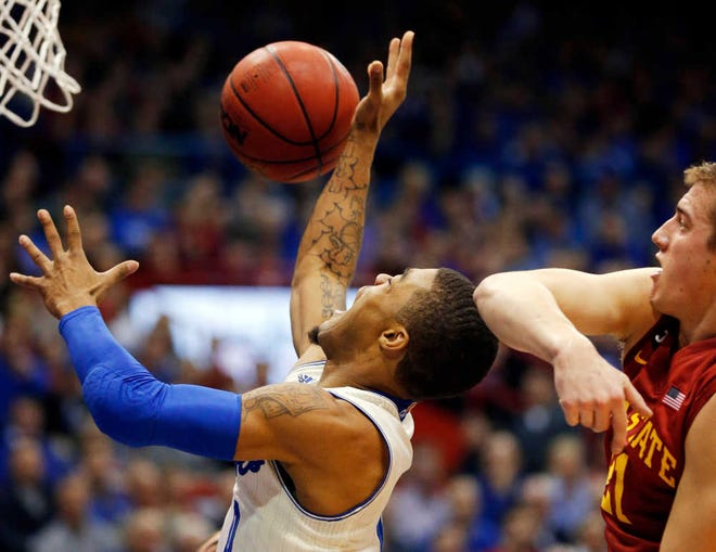 Kansas guard Frank Mason, left, gets this shot blocked by Iowa State's Matt Thomas during the first half, but Mason drilled a critical 3-pointer late in the game to stave off a Cyclone comeback.