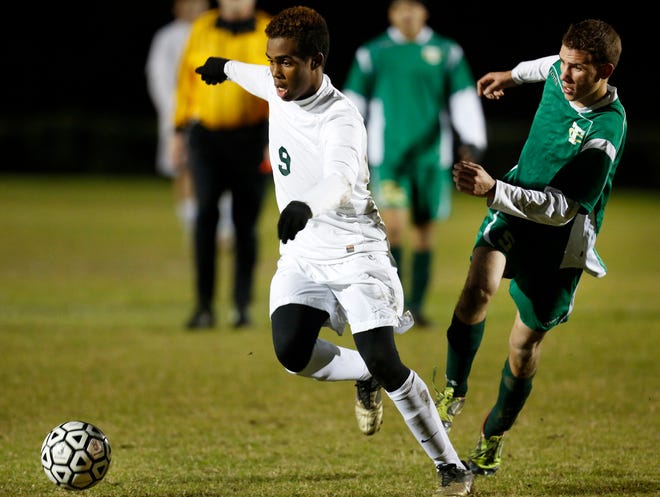 Eastside's Tyler Miller-Jones (9) moves the ball upfield against Trinity Catholic's Anthony DeSimone during the Region 2-2A quarterfinals at Citizens Field Thursday night.