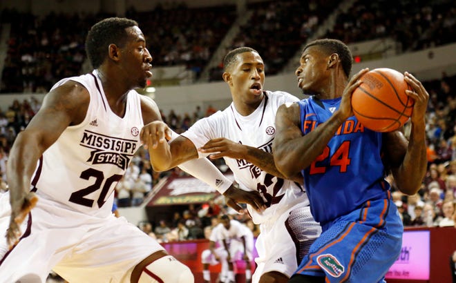 Florida forward Casey Prather looks for an open teammate while Mississippi State forward Gavin Ware (20), left, and guard Craig Sword defend in the second half in Starkville, Miss. on Thursday. No. 3 Florida won 62-51. (AP Photo)