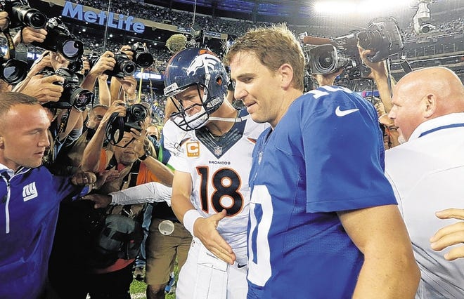 Broncos QB Peyton Manning, left, brought the pain to his little brother Eli and the Giants in September.