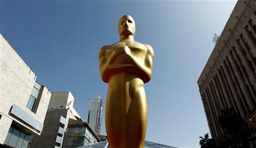 In this Feb. 25, 2012 file photo, a Oscar statue is seen on the red carpet before the 84th Academy Awards in Los Angeles. The motion picture academy is honoring employees of film laboratories with an honorary Oscar statuette. The Academy of Motion Pictures Arts and Sciences said Wednesday, Jan. 8, 2014, other Scientific and Technical Awards recipients this year will include visual effects supervisor Peter W. Anderson and executive Charles “Tad” Marburg. Portions of the Scientific and Technical Awards presentations will be included in the Academy Awards broadcast on March 2, 2014.