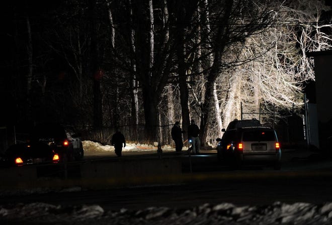 Norwood police on the scene of where a body was found Wednesday evening in a wooded area behind the Coakley Middle School athletic fields, January 29, 2014.