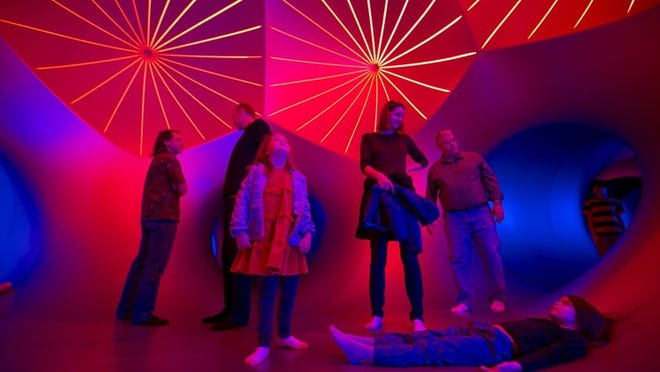 People crowd into one of the larger spaces inside the new Architects of Air luminarium, Miracoco, at the Long Center.