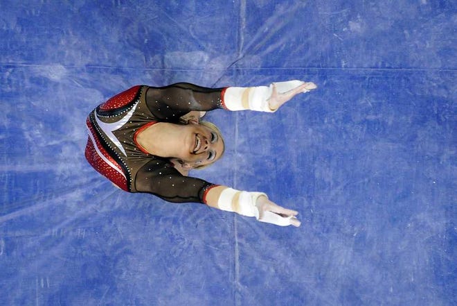 Georgia gymnast Chelsea Davis dismounts after performing on the uneven bars during a gymnastics meet against LSU in Athens, Ga., Friday, Jan. 17, 2014. (AJ Reynolds/Staff, @ajreynoldsphoto)