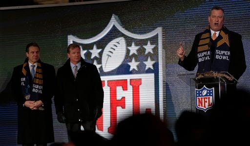 New York City Mayor Bill de Blasio, right, speaks while NFL comissioner Roger Goodell, center, and New York Gov. Andrew Cuomo, left, look on during a ceremony unveiling the Roman numerals for Super Bowl XLVIII on Super Bowl Boulevard Wednesday, Jan. 29, 2014, in New York. The Seattle Seahawks are scheduled to play the Denver Broncos in the NFL Super Bowl XLVIII football game on Sunday, Feb. 2, in East Rutherford, N.J. (AP Photo/Charlie Riedel)