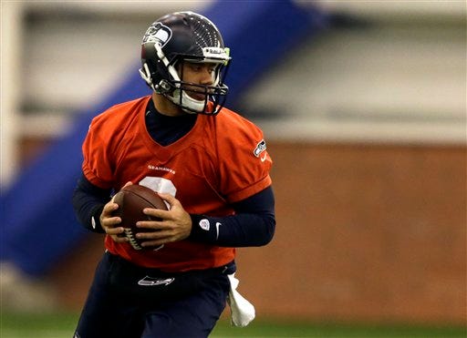 Seattle Seahawks quarterback Russell Wilson drops back during NFL football practice Thursday, Jan. 30, 2014, in East Rutherford, N.J. The Seahawks and the Denver Broncos are scheduled to play in the Super Bowl XLVIII football game Sunday, Feb. 2, 2014.
