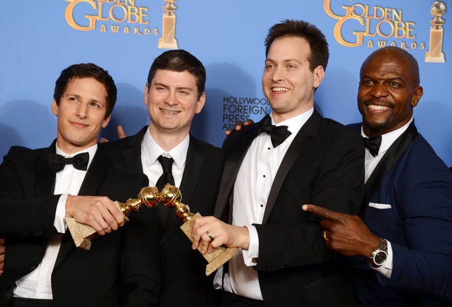 From left, Andy Samberg, Michael Schur, Dan Goor and Terry Crews pose in the press room with the award for best television series - comedy or musical for "Brooklyn Nine - Nine" at the 71st annual Golden Globe Awards last month.