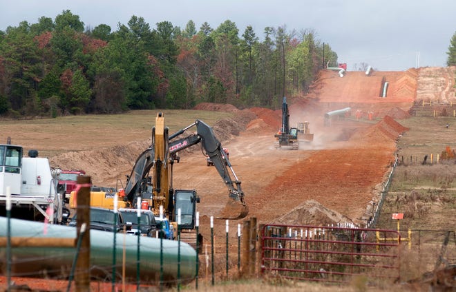 In this Dec. 3, 2012 file photo, crews work on construction of the TransCanada Keystone XL Pipeline near County Road 363 and County Road 357, east of Winona, Texas. In a move that disappointed environmental groups and cheered the oil industry, the Obama administration on Jan. 31, 2014, said it had no major environmental objections to the proposed Keystone XL oil pipeline from Canada.