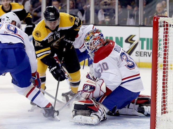 Montreal Canadiens goalie Peter Budaj makes a save as Boston Bruins right wing Jarome Iginla looks for a rebound during the second period of an NHL hockey game on Thursday, Jan. 30, 2014, in Boston.