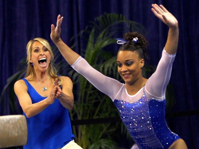 Florida head coach Rhonda Faehn cheers at the end of the beam routine by Kytra Hunter against the Georgia Bulldogs at the Stephen C. O'Connell Center on Friday, Jan. 24.