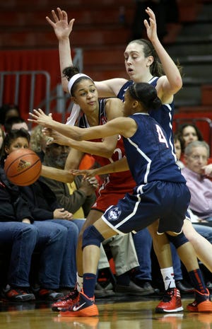 Cincinnati guard Alyesha Lovett, center, is trapped by UConn guard Moriah Jefferson, right front, and forward Breanna Stewart during their game in Cincinnati. The Huskies won, 86-29. THE ASSOCIATED PRESS