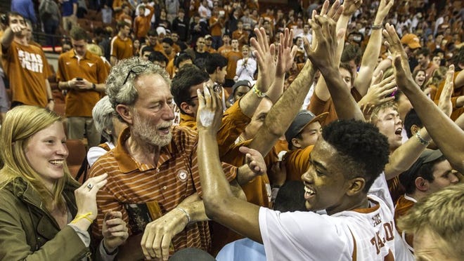 Texas’ Isaiah Taylor celebrates with Erwin Center fans after an 81-69 upset of Kansas on Saturday.