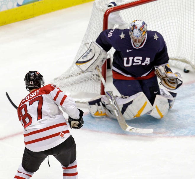 FGILE - In a Feb. 28, 2010 file photo Canada's Sidney Crosby (87) shoots past USA goalie Ryan Miller (39) for the game-winning goal in the overtime period of a men's gold medal ice hockey game at the Vancouver 2010 Olympics in Vancouver, British Columbia. Crosby will captain the Canadian hockey team at the Olympics in Sochi. (AP Photo/Chris O'Meara, file)