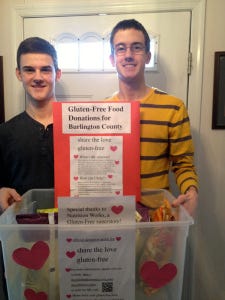 Brothers Nathan (left) and Nicholas Emery of Shamong show the bin they're using to collect donations of gluten-free foods. The donations will be delivered to area food pantries and soup kitchens, where they will be distributed to people in need, who are on a gluten-free diet. Thecollection is part of the Share the Love - Gluten Free campaign overseen by the Theta Lambda Chapter of the Eta Sigma Alpha National Homeschool Honors Society.