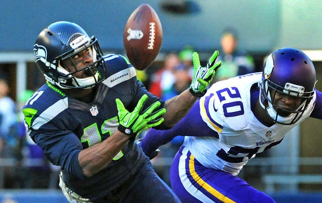 Seattle wide receiver Percy Harvin catches a 17-yard pass from quarterback Russell Wilson as Minnesota cornerback Chris Cook, right, defends on Nov. 17, 2013, in Seattle. The catch was Harvin's only reception of the regular season.