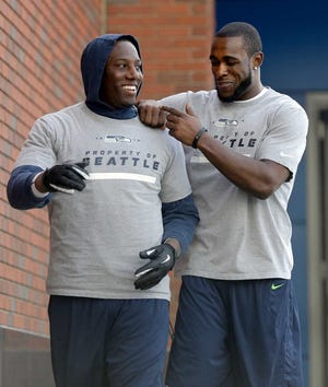 Seattle Seahawks defensive end Chris Clemons, left, and safety Kam Chancellor joke as they head to the New York Giants' NFL practice facility for a final walkthrough Saturday, Feb. 1, 2014, in East Rutherford, N.J. The Seahawks and the Denver Broncos are scheduled to play in the Super Bowl XLVIII football game Sunday, Feb. 2, 2014. (AP Photo/Jeff Roberson)