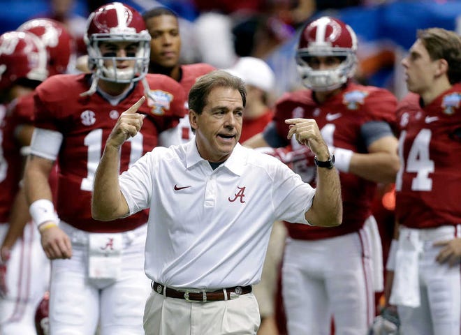 FILE - In this file photo from Jan. 2, 2014, Alabama head coach Nick Saban, center, calls drills as his team warms up before the NCAA college football Sugar Bowl against Oklahoma in New Orleans. The Southeastern Conference is still reigning supreme on the recruiting trail. The Crimson Tide is poised to bring in another top-rated recruiting class on Wednesday's, Feb. 5, 2014, national signing day. Six SEC rivals also have built top 10 classes, according to the 247Sports composite rankings of the major recruiting sites. (AP Photo/Rusty Costanza, File)