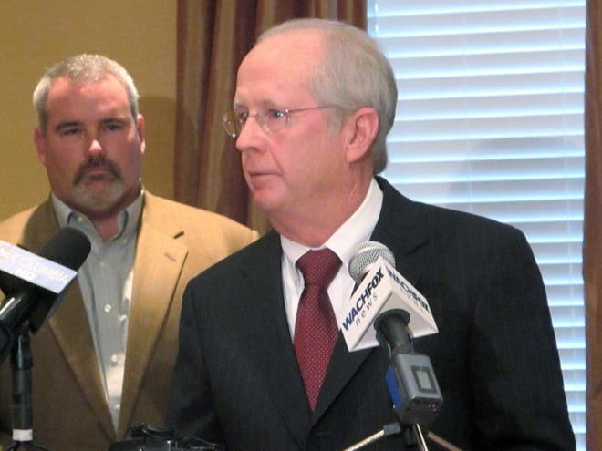 John Durst, right, president and CEO of the South Carolina Restaurant and Lodging Association, speaks during a news conference Monday in Columbia. Behind him is Chalmers Carr, the owner of Titan Farms in South Carolina.