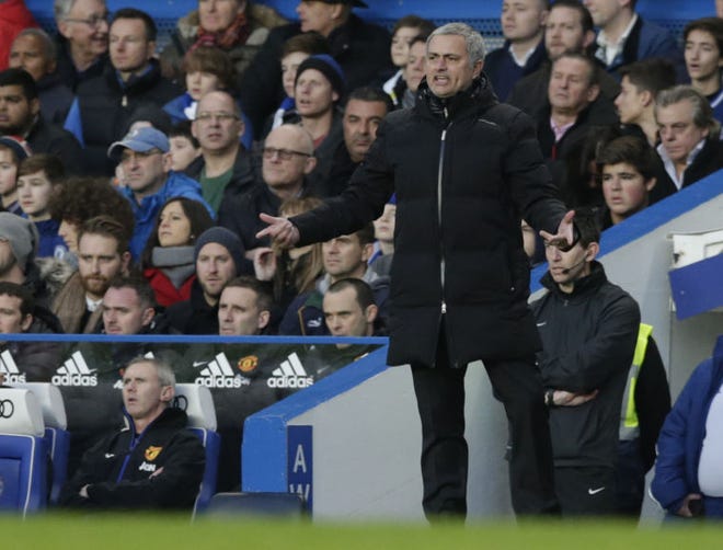Chelsea's manager Jose Mourinho watches his team from the sidelines during the English Premier League soccer match between Chelsea and Manchester United at Stamford Bridge stadium in London, Sunday, Jan. 19, 2014. (AP Photo/Matt Dunham)