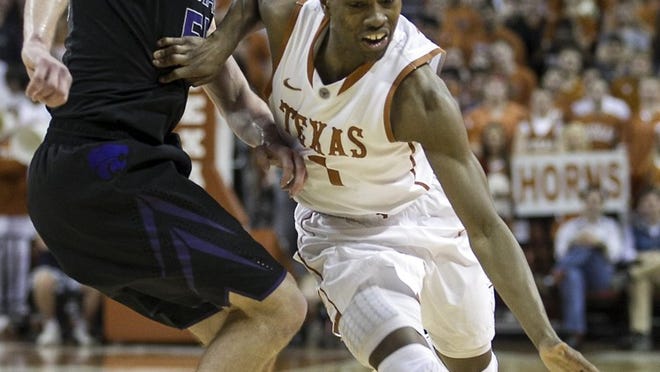 Texas point guard Isaiah Taylor, shown driving past Kansas State’s Will Spradling, was named the Big 12’s rookie of the week Monday after a 23-point effort in the Longhorns’ win over Kansas on Saturday.