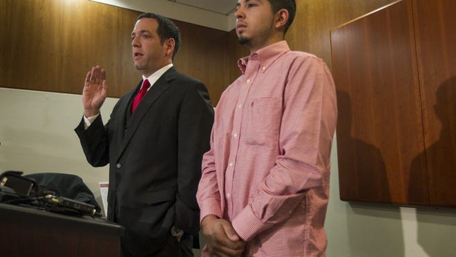 Attorney Adam Loewy, left, discusses the lawsuit he has filed for the family of Noe Nino de Rivera, 17, as Noe’s brother Jesus Nino de Rivera, right, looks on during a press conference in Austin, Tx., on Tuesday, November 26, 2013. (RODOLFO GONZALEZ / AMERICAN-STATESMAN )