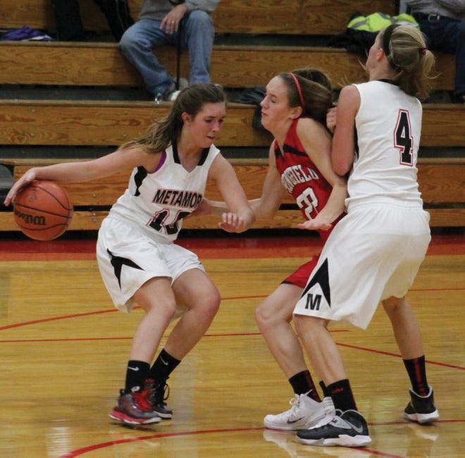 Sophomore Heather DeLuca makes a move past Springfield with senior Kara Hartnett setting the pick in a previous game. DeLuca scored 11 points against Pekin Saturday.