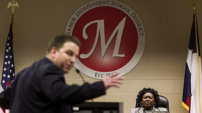 Bradley Clark, an attorney and parent in the Manor school district turns toward the audience as he speaks out against Board President Desiree Cornelius-Fisher, right, at a school board meeting Tuesday night. Trustees said they will discuss at a future meeting whether to open an investigation into abuse of power and misuse of district funds by any board member.