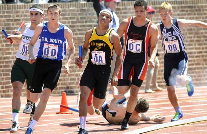 Pennridge's Joey Logue (far left) and the other runners head around the turn during the High School Boys 4x400 Suburban One National race at the 2013 Penn Relays.