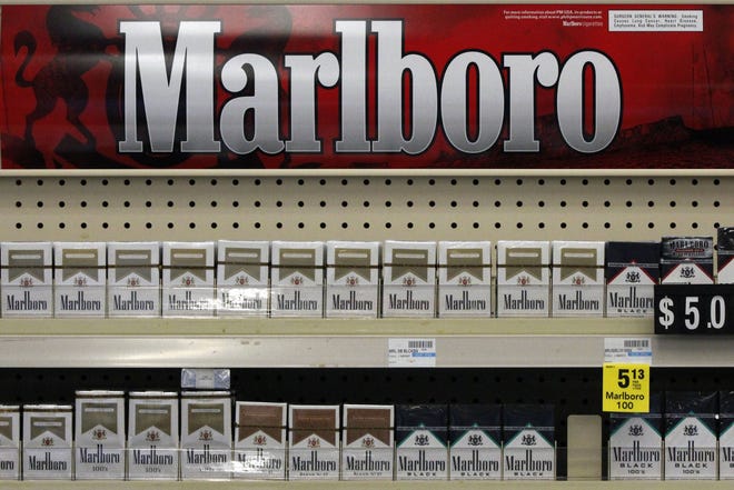 In this Wednesday, July 17, 2013, file photo, Marlboro cigarettes are on display in a CVS store in Pittsburgh. The nation's second-largest drugstore chain says it will phase out cigarettes, cigars and chewing tobacco by Oct. 1, 2014, as it continues to focus more on health care. The move will cost the Woonsocket, R.I., company about $2 billion in annual revenue.