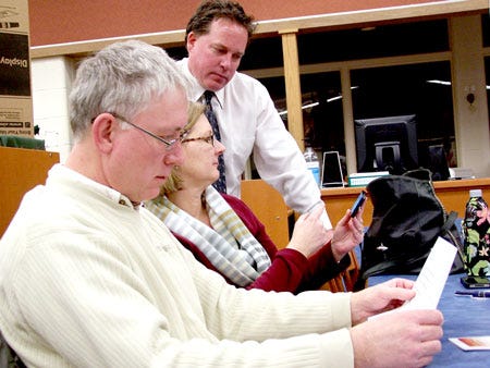 White Pigeon Superintendent Ron Drzewicki shows a map of the district's boundaries to White Pigeon Township residents Leonard and Denice Hinkson at Wednesday’s Yes Committee meeting. The district is seeking a 1-mill increase in May.