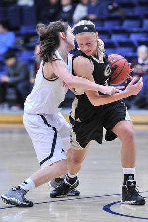Emporia State's Rheanna Egli steals the ball from Washburn's Taylor Ignoto on Wednesday at Lee Arena. The Hornets outscored the Bods 32-9 over the game's final 9:42 to claim a six-point victory.