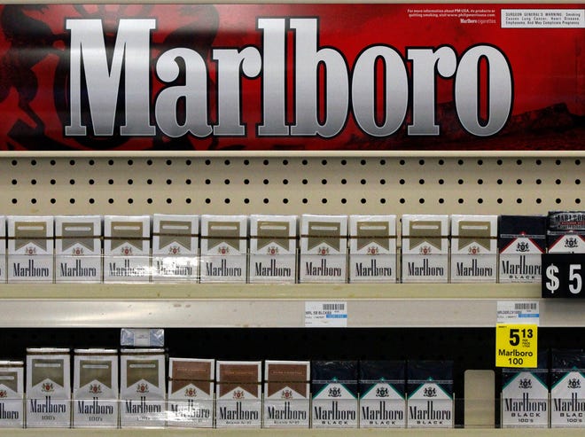FILE - In this Wednesday, July 17, 2013 file photo, Marlboro cigarettes are on display in a CVS store in Pittsburgh. The nation's second-largest drugstore chain says it will phase out cigarettes, cigars and chewing tobacco by Oct. 1 as it continues to focus more on health care. The move will cost the Woonsocket, R.I., company about $2 billion in annual revenue.