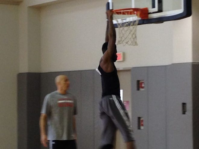 Rookie center Nerlens Noel hangs on the rim after dunking during a drill Thursday.