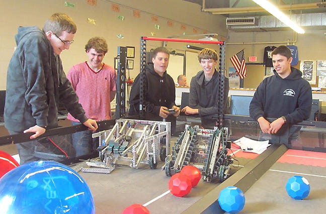 WHS junior Perry Hayes and seniors Joseph Chouinard, Dylan Cox, Tanner Quinn and Robert Harwood demonstrate how their robot works.