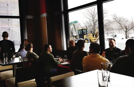 People have lunch by the windows in Portsmouth’s newest restaurant, BRGR Bar, which opened Wednesday despite the snowstorm.