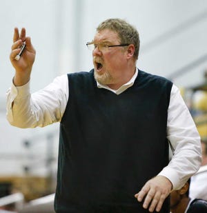 Topeka High's Head Coach Pat Denney calls out the play to his team during the second half of Thursday night's game against Olathe South during the Topeka Invitational Tournament.