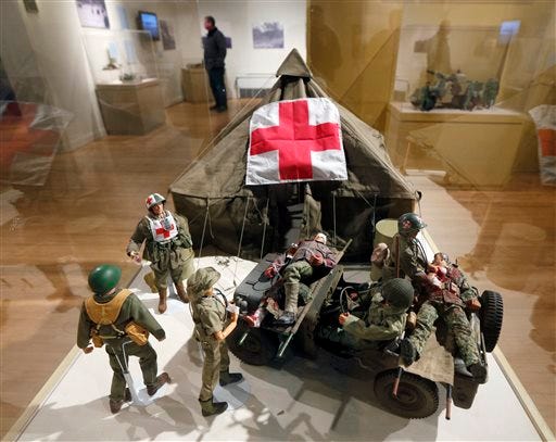 In this Jan. 31, 2014 photo shows G.I. Joe action figures are arranged in a mobile army surgical hospital in a display at the New York State Military Museum in Saratoga Springs, N.Y. A half-century after the 12-inch doll was introduced at a New York City toy fair, the iconic action figure is being celebrated by collectors with a display at the military museum, while the toy's maker plans other anniversary events to be announced later this month.