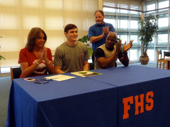 Gabe Moore, a 6-foot-2, 185-pound Freeport Bulldog, signed a letter of intent to run track and field with the University of Arkansas Wednesday morning at Freeport High. Seated from left is his mother Chris Pulsifer, Moore and Coach Willie Parker. Standing in back is Freeport Athletic Director Jim Anderson. "This may be our first true Division I scholarship," Anderson said. "We're proud of him and wish him the best of success.'