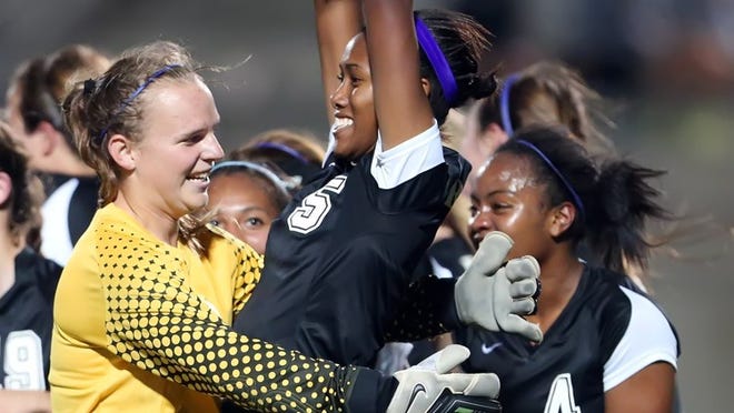 Cedar Ridge’s Chrissy Pitre, center, celebrates scoring a goal against Hendrickson during a 2013 playoff game. Pitre has signed to play soccer for LSU. CREDIT: Jamie Harms/For American-Statesman