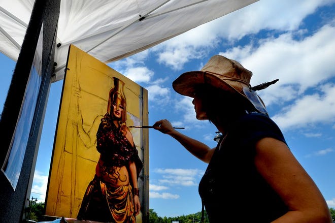 FILE PHOTO: Artist Tracey Frugoli works on her oil painting Athenaat Saturday's Wine Walk at Junction City. The benefit for the Peoria Art Guild featured a variety of wines to taste, artists and musical entertainment.