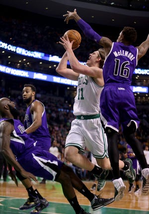Celtics center Kelly Olynyk (41) drives to the basket against Kings shooting guard Ben McLemore (16) and Quincy Acy (front left) during Boston's win Friday.