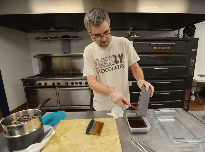 Wes Unruh of Unruly Chocolate tempers chocolate before hand making truffles at the Mama Bird's Granola Shared Commercial Kitchen on Thursday, Feb. 6, 2014, in Athens, Ga. (Richard Hamm/Staff) OnlineAthens / Athens Banner-Herald