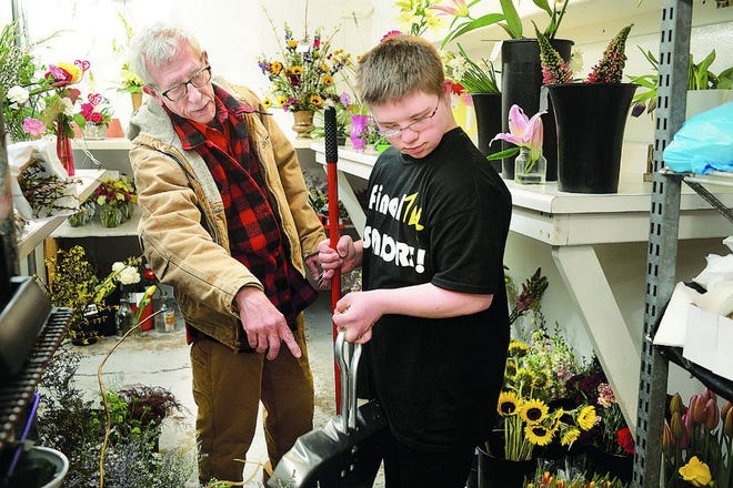 Gregg's Florist owner Dan Callahan advises Adam West on work to be done in the cooler of the Peoria Heights flower shop Tuesday. West, 18, and a senior at Dunlap High School, is a client in the STEP program that works to get disabled people jobs in the community.
