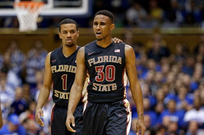 Florida State's Ian Miller (30) and Devon Bookert (1) react to a foul during the second half of an NCAA college basketball game against Duke in Durham, N.C., Saturday, Jan. 25, 2014. Duke won 78-56. (AP Photo/Gerry Broome)