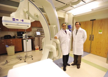 Dr. Lazaro Diaz, left, and Dr. William Danford, cardiologists at Wentworth-Douglass Hospital in Dover, show off the hospital's catheterization lab.